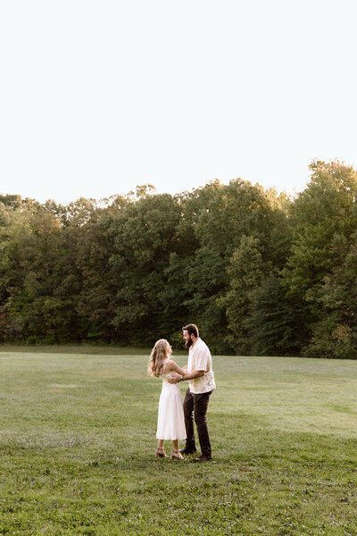 Couple in a field in Cuyahoga Valley National Park during an engagement session.