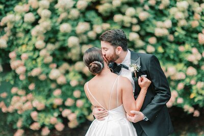 Groom kissing bride on the cheek