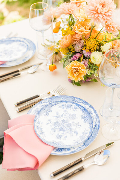Blue painted china, wedding reception dinner set up with orange and pink centerpiece florals, Milwaukee WI Photographers, Waukesha Wisconsin.