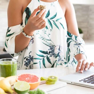 Woman with halved grapefruit and green juice