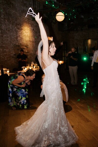 Bride partying during wedding reception at Wythe Hotel