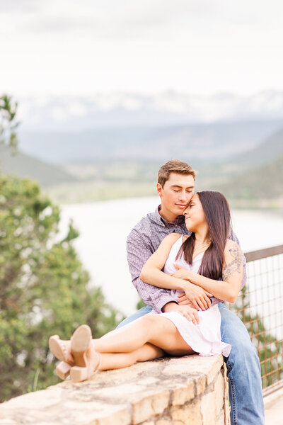 couple cuddling on rock ledge at ridgway state park, co