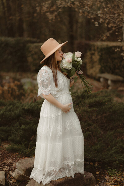 Mother with white dress and roses by Lawrenceville Maternity Photographer