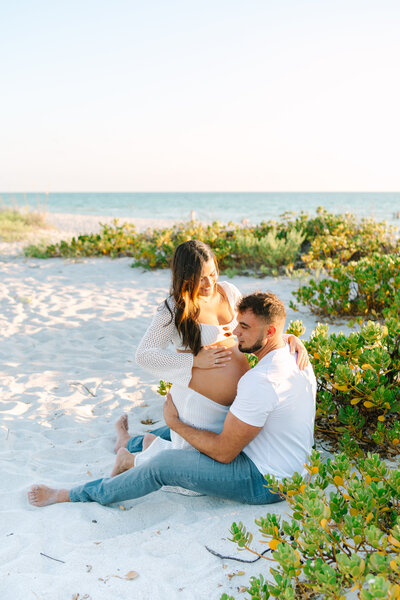 Child swinging with parents | Fun Maternity Photoshoot Pose