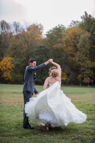 a groom twirling his bride