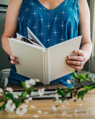 Montana wedding photographer Carin Rene holding wedding album