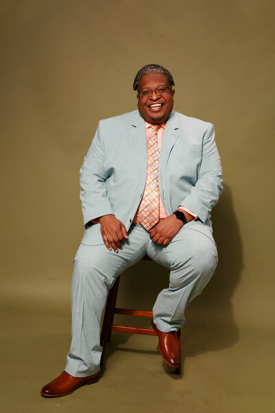 a black male therapist smiling to the camera in a mental health clinic in Massachusetts