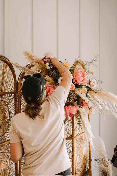 A florist working on a floral arrangement 