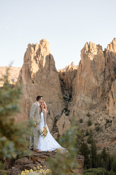Bride and groom embracing at Smith Rock State Park. 