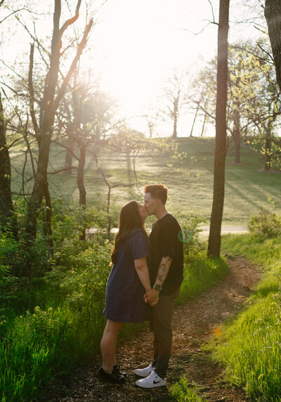 An indie LGBTQ+ couple’s moody editorial wedding portrait, photographed in a true-to-color style by Chelsea Stanford in Missouri.