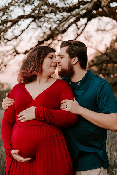 couple holding baby belly