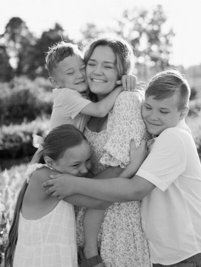 Mother with children sitting in a field