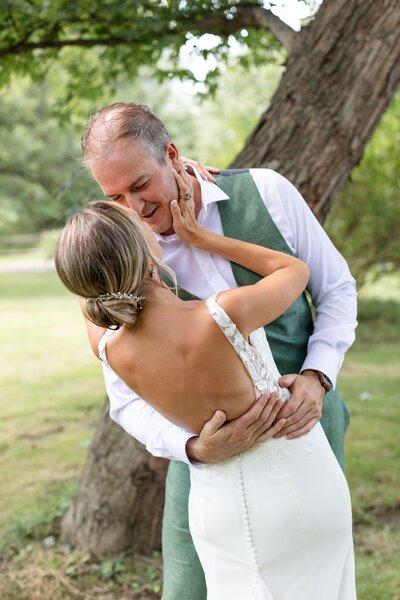 Groom dips his new bride during their wedding portraits at Sydenham Ridge Estates