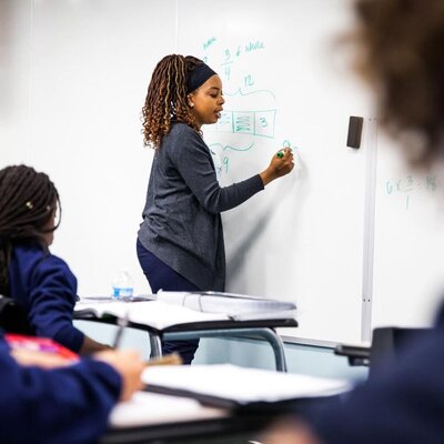 Deonna writing on a whiteboard