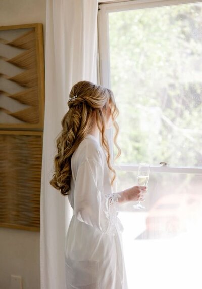 bride looks out window at atlanta wedding venue