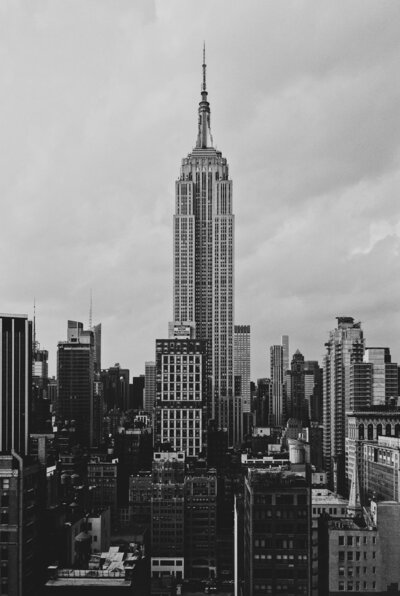 A striking black and white photograph of the New York skyline, capturing the iconic skyscrapers and architectural grandeur, evoking a sense of classic urban elegance.