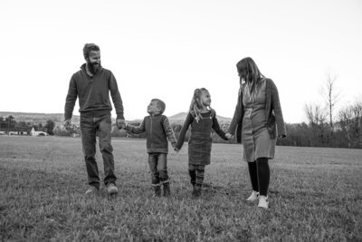 Family holding hands in a field | Family Photography