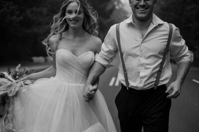 Bride and Groom holding hands running in the street