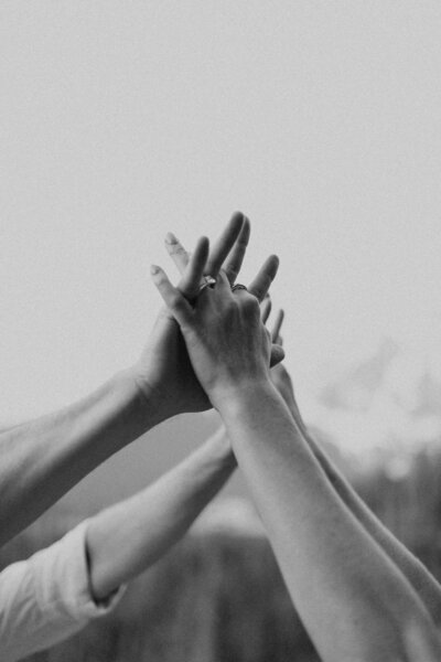 couple holding hands reaching up