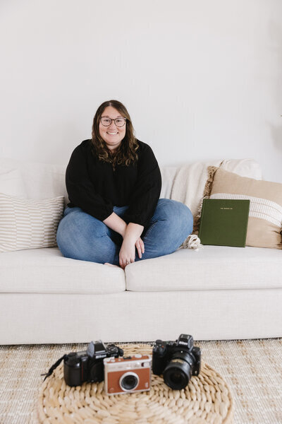 Mid Michigan wedding photographer Catie Eovaldi sitting on couch