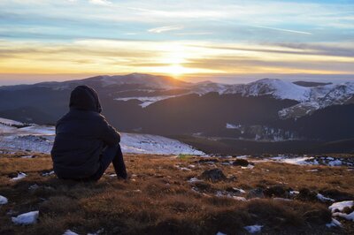 Person looking mindfully at the city, feeling calm and connected