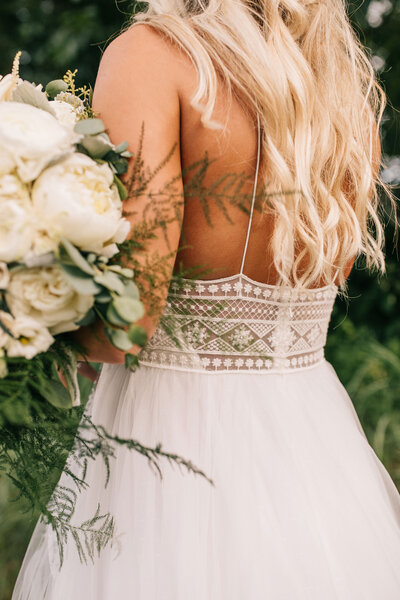 Back of bride with her dress and flowers