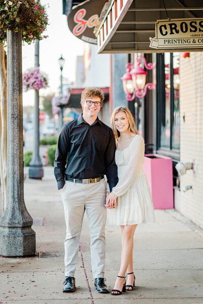 Engaged couple stops for a photo in downtown Conway, Arkansas.