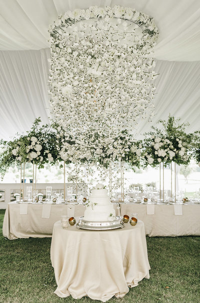 luxury indoor tented wedding with hanging floral display