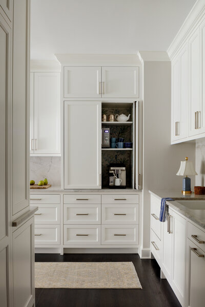 Bright light white and modern kitchen with dark wood flooring