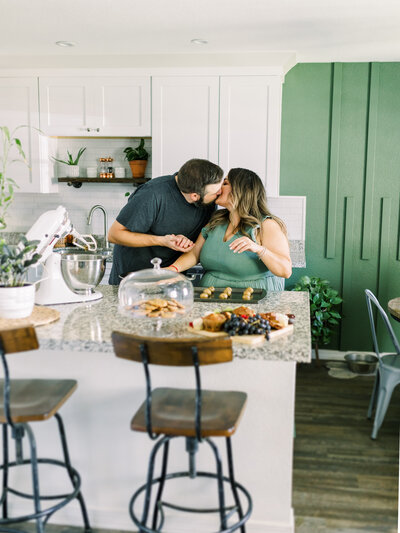couple kissing in the kitchen
