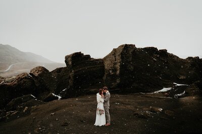 Bride and groom stand with their foreheads touching at their adventure elopement in Iceland. 