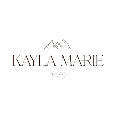 Kayla Marie, Midwest wedding photographer, smiling with camera, capturing authentic love stories.