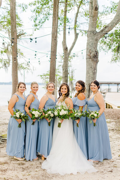 a bride posing with her bridesmaids