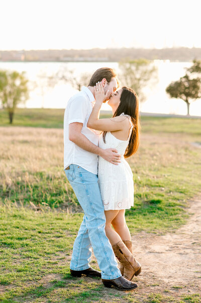 Couple kissing at outdoor Texas engagement session