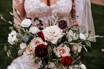 Bridal bouquet featuring a soft color palette of pink, white, and pastel blooms by Leigh Florist for a classic wedding.