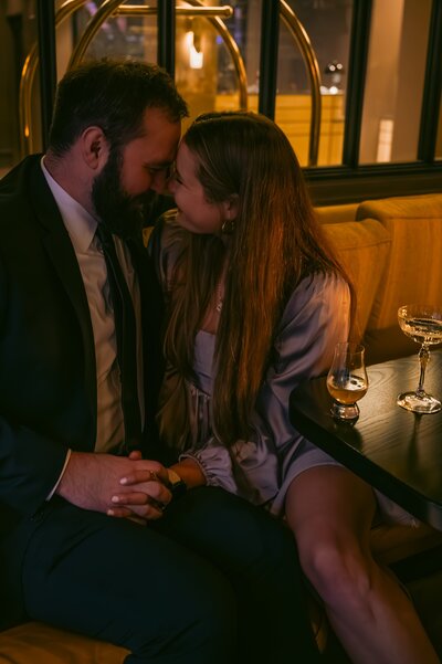 moody and romantic engagement photo in a  bar