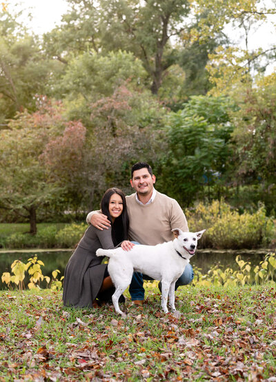 Family with dog in front of pond in Michigan