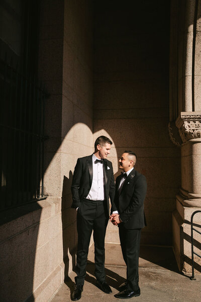 groom and groom holding hands