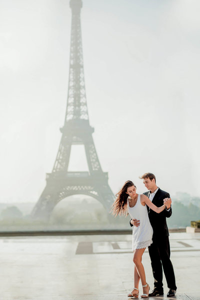 Fashion Charleston Photographer captures couple with the Eiffel Tower behind them, Paris, France. Fashion photographer.