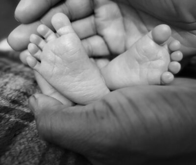 newborn baby feet in parent hands