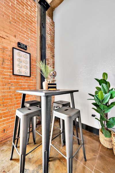 Bar height seating for four in this two-bedroom, two-bathroom vacation rental condo in the historic Behrens building in downtown Waco, TX just blocks from the Silos, Baylor University, and Spice Street.