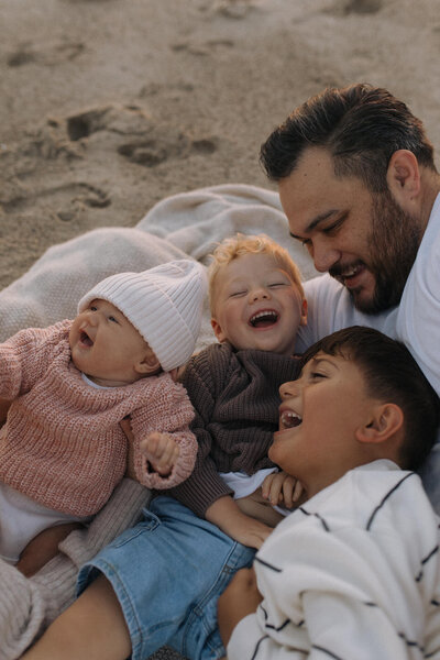 family of 4 laughing together