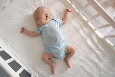 baby sleeping in crib by himself
