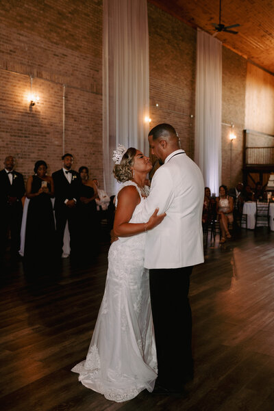 A bride and groom have a dance outside of their churh