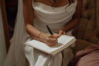 Bride writing her vows  during their wedding at Caleb Pike in Victoria by Latitude 49 Photography