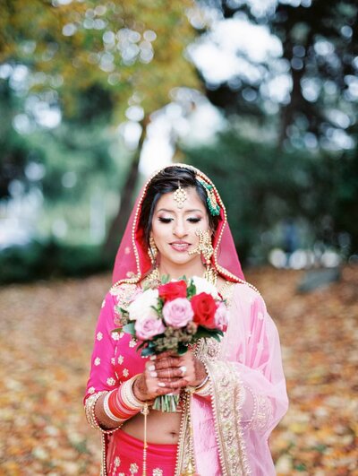 Indian bride holding a bouquet in traditional outfit