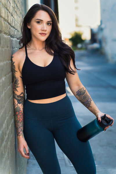 brand photo of  fitness coach with a water bottle in one of her hands