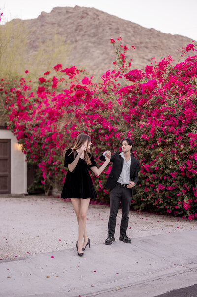 A romantic dance beneath vibrant bougainvillea, set against the dreamy Palm Springs backdrop. This image embodies timeless elegance and effortless connection in the golden desert light.
