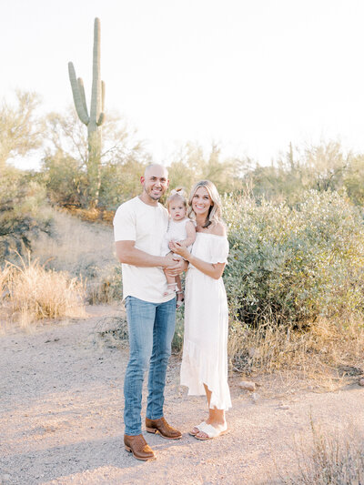 Man and woman posing with young girl in a desert