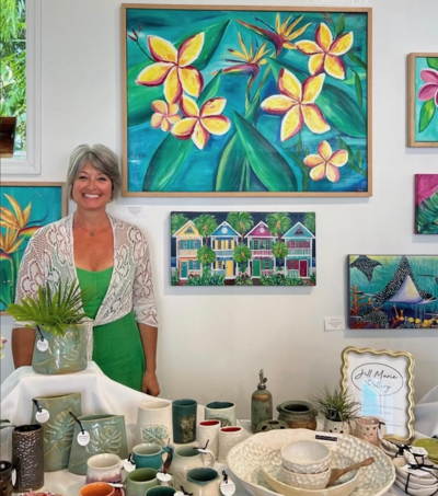 Jill stands beside a table of her handmade pottery inside Sacred Space Gallery in Key West, FL